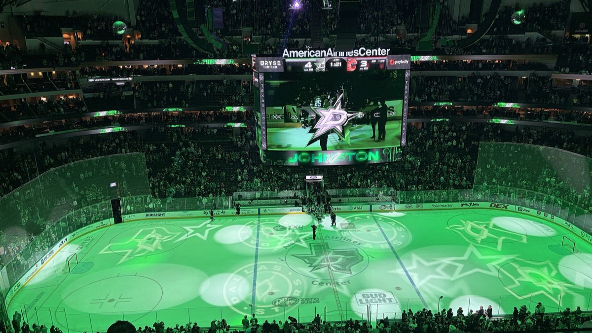 The rink at American Airlines Center in Dallas lit green after a Stars win