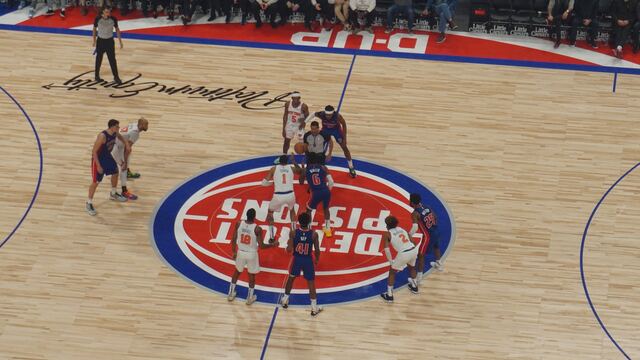 Jump ball at center court during a Knicks vs Pistons game at Little Caesars Arena in Detroit