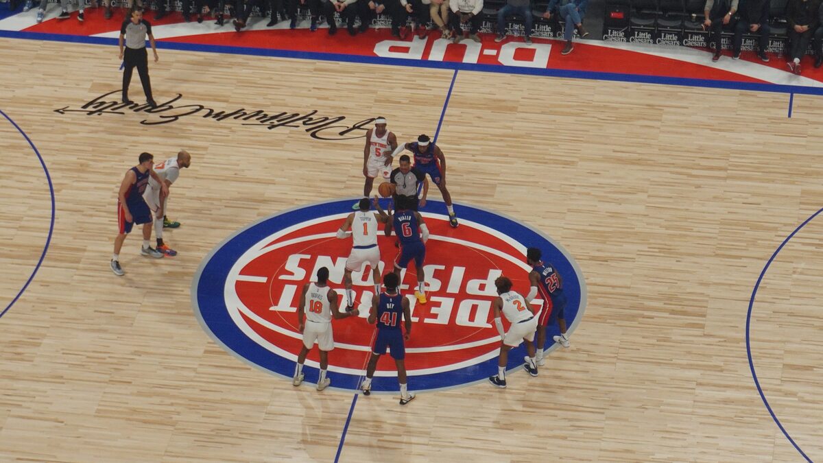Jump ball at center court during a Knicks vs Pistons game at Little Caesars Arena in Detroit