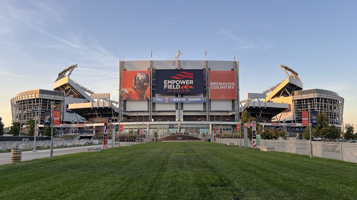 Empower Field at Mile High in Denver seen from the lawn in front of its main entrance